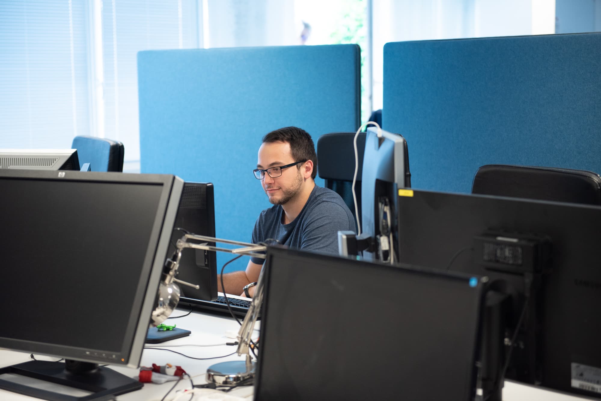 FX Software developer working at his desk in the Budapest office